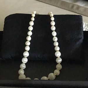 White silk wrapped beads in silk bag.
